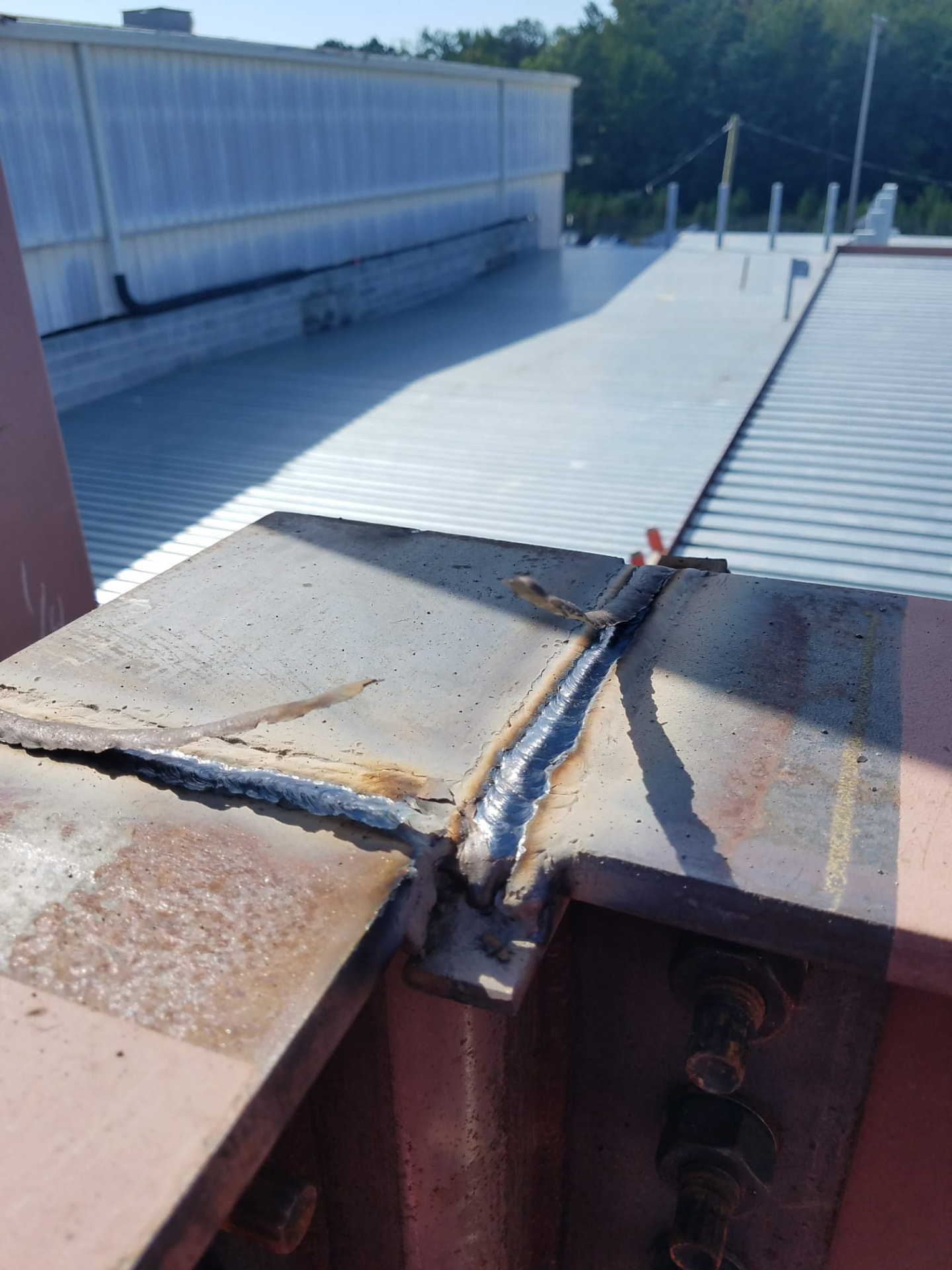 Rooftop steel beam splice weld on a commercial building